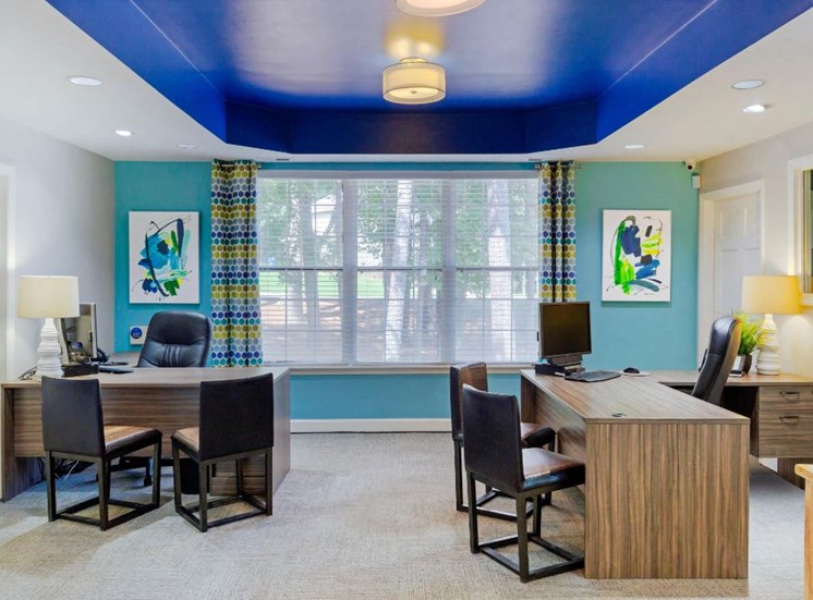 Leasing Office Desks with Chairs and Light Blue Accent Wall